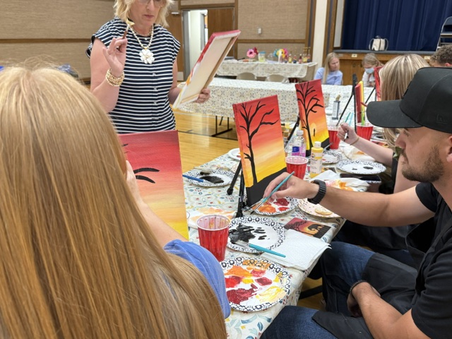 An instructor demonstrating a brush technique to the group
