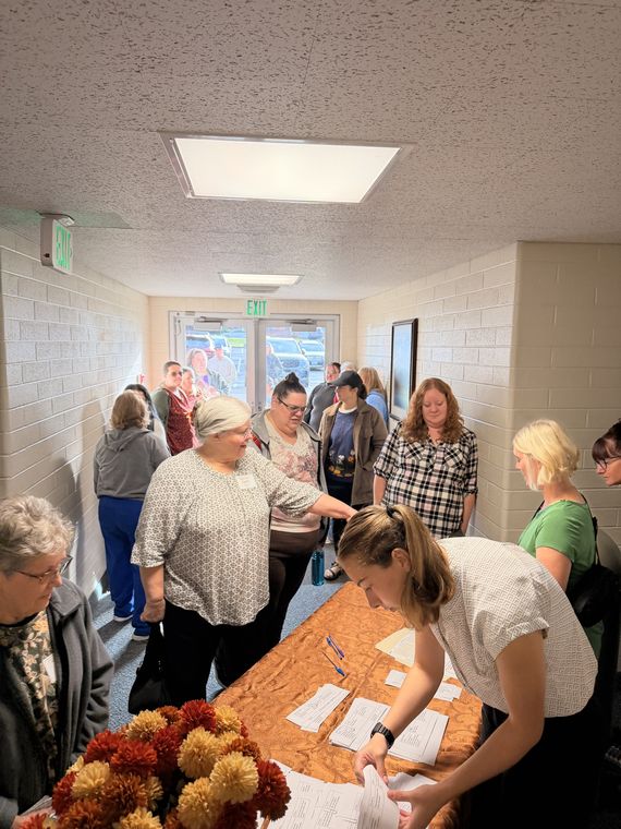 Sisters gathered at the registration table in the hallway, signing in