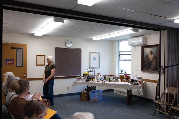 Victoria Yeates teaching beside a table of natural remedies and essential oils